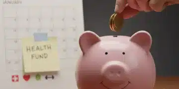 Hand putting coins into a piggy bank with '2026' on a calendar, symbolizing health savings.